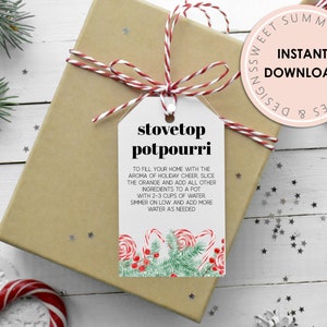 May include: A printable gift tag with a red and white striped ribbon, featuring a festive design of candy canes and evergreen sprigs. The tag reads "Stovetop Potpourri" and includes instructions for making a holiday-scented simmer pot.