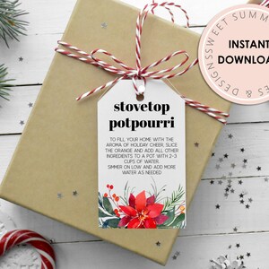 May include: A printable gift tag with a red and white striped ribbon, a white background, and the text "stovetop potpourri". The tag includes instructions for making stovetop potpourri with orange slices and other ingredients. The tag is decorated with a watercolor illustration of a red poinsettia.