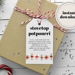May include: Printable gift tag with a white background and red and white twine. The tag has black text that reads "stovetop potpourri" and instructions for making stovetop potpourri. The tag is decorated with small red and white gift boxes.