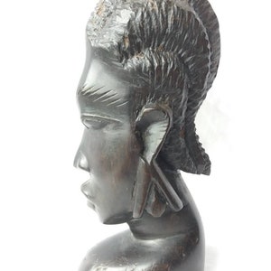 African head of a woman sculpture. ebony carving. african art. West Africa. tribal art. beautiful face. Hair braids.