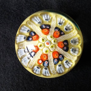vintage Strathearn glass millefiore paperweight in blue, red, yellow and white on yellow. seven spoke latticino canes. Scottish Glass. S78