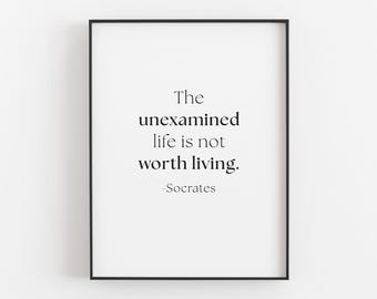 May include: A framed print with a white background and black text. The text reads "The unexamined life is not worth living." The quote is attributed to Socrates. The frame is black.