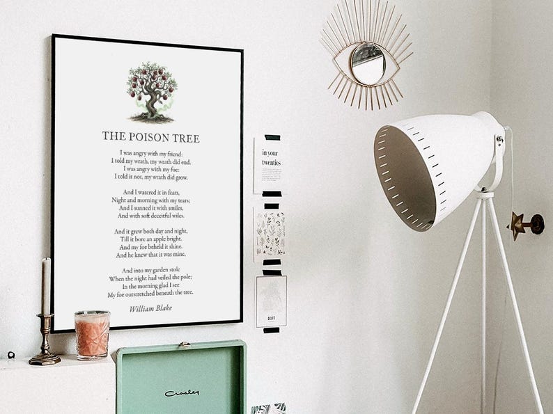 May include: A framed print of William Blake's poem "The Poison Tree" with a tree illustration. The room features a white tripod floor lamp, a decorative eye-shaped mirror, and a small green record player.