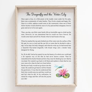 May include: A framed print featuring the story "The Dragonfly and the Water Lily." The text is in a classic font, with a watercolor illustration of a dragonfly and a water lily. The frame is a light wood color.