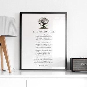 May include: A framed print of William Blake's poem "The Poison Tree" with a tree illustration. The black framed print is displayed on a white shelf with a lamp and speaker.