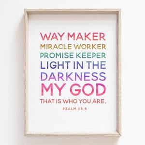 May include: A framed print with a white background and a rainbow gradient text that reads "Way Maker, Miracle Worker, Promise Keeper, Light in the Darkness, My God, That is who you are. Psalm 113:5".