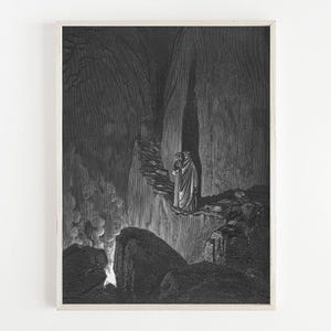 May include: Framed monochrome print featuring a detailed illustration of two robed figures on a rocky path in a dark, cavernous setting. The artwork uses light and shadow to create a dramatic effect, suggesting a mysterious narrative within a landscape.