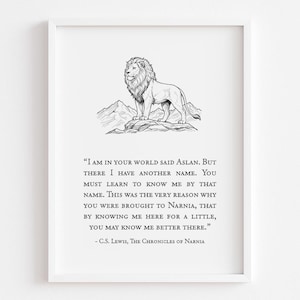 May include: A framed print featuring a black and white illustration of a lion standing on a mountain, with text from C.S. Lewis's "The Chronicles of Narnia". The quote is centered below the lion image.