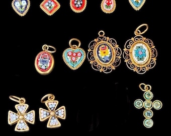 May include: A collection of eleven gold-tone metal pendants featuring colorful micro-mosaic floral and geometric designs. The assortment includes heart, oval, diamond, and cross shapes, each with a small loop for attachment to a chain or cord.