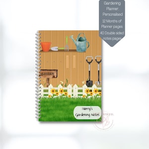May include: A gardening planner notebook featuring a brown wooden fence, a red bucket, a watering can, a shovel, and a rake. The notebook has a green grass background and a white picket fence. The text "GARDEN" is on a wooden sign. The text "Harry's Gardening Notes" is on a white label.