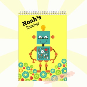 May include: A yellow drawing book with a spiral binding. The cover features a cartoon robot with a lightbulb on its head and the text "Noah's Drawings".