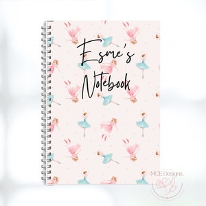 May include: A pink notebook with a spiral binding. The cover features a repeating pattern of ballerina illustrations in pink and blue. The text "Esmé's Notebook" is written in black cursive on the front cover.