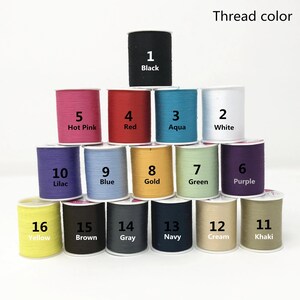 May include: A collection of 16 spools of thread in various colors, numbered 1 through 16. The thread colors include black, hot pink, red, aqua, white, lilac, blue, gold, green, purple, yellow, brown, gray, navy, cream, and khaki.