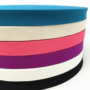 May include: A stack of six cotton webbing straps in various colors, including teal, cream, pink, purple, cream, and black.