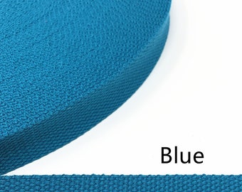 May include: A close-up of a roll of blue webbing. The webbing is woven with a textured pattern. The word "Blue" is printed below the webbing.