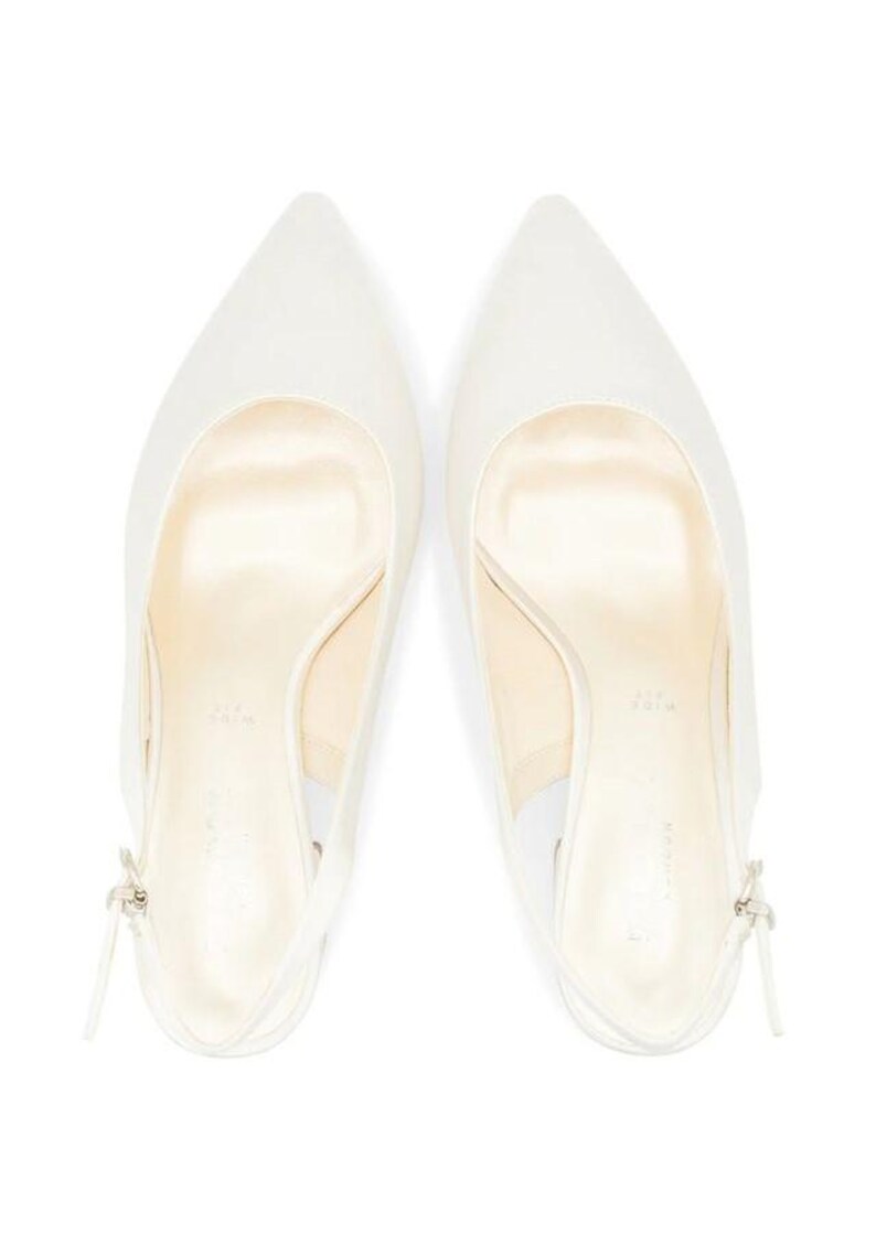May include: A pair of white satin slingback heels with a pointed toe.