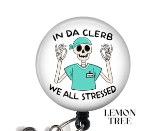 May include: A white round badge holder with a black retractable cord. The badge features a cartoon skeleton wearing a blue surgical scrub and the text "In Da Clerb We All Stressed".