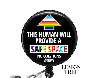 May include: Black and white button with a rainbow arrow pointing up and the text "This human will provide a safe space. No questions asked."