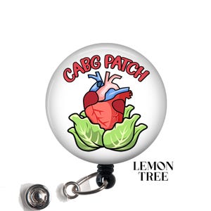 May include: A white badge holder with a red, blue, and green cartoon heart inside a green lettuce. The badge holder has the text "CABG PATCH" in red letters.