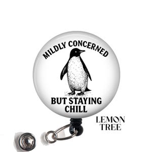 May include: White badge reel with a black and white penguin illustration and the text "Mildly Concerned But Staying Chill".