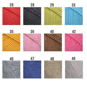 May include: A collection of yarn skeins in various colors, including red, black, yellow, green, blue, pink, brown, and gray. The skeins are labeled with numbers from 26 to 49.