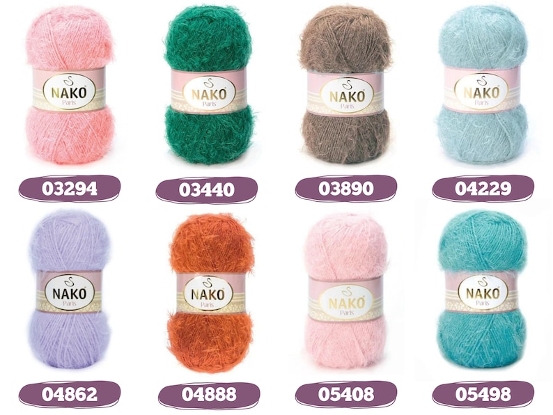 Op de afbeelding: Een verzameling van acht kleurrijke Nako Paris garenbollen. De bollen zijn in verschillende tinten, waaronder roze, groen, bruin, blauw, paars, oranje en turquoise. Elke bol heeft een label met de merknaam en een unieke kleurcode. Geschikt voor brei- en haakprojecten.