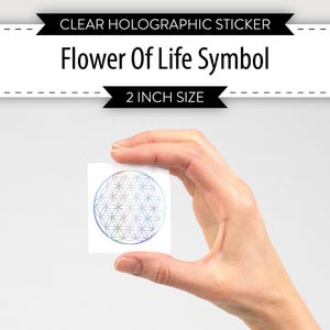 May include: A clear holographic sticker with a 2 inch size featuring the Flower of Life symbol. The symbol is a geometric pattern of overlapping circles.