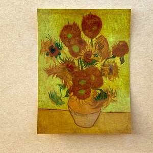 May include: A painting of a vase filled with sunflowers. The sunflowers are yellow with brown centers and are arranged in a loose, organic way. The background is a yellow-green color.