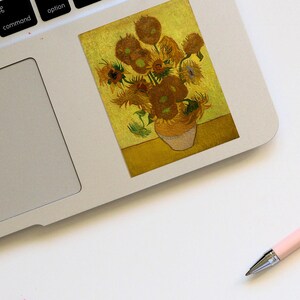 May include: A painting of a vase of sunflowers. The sunflowers are yellow and brown, and the vase is white. The background is a yellow-gold color.
