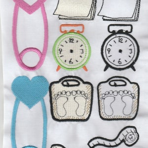 May include: Embroidered design featuring a pink and blue safety pin, two clocks, two scales, a measuring tape, and hearts. The design is perfect for a baby shower or nursery.