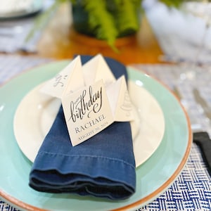 Paper fortune teller on blue napkin and blue plate