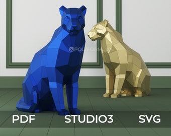 May include: Two origami papercraft animal sculptures, one blue and one gold, in the shape of a sitting cat or panther. The sculptures are on a green wooden floor with the words "PDF", "STUDIO3", and "SVG" printed below them.