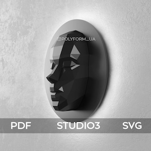 May include: A black and white geometric papercraft sculpture of a face. The sculpture is mounted on a round white base. The text "@POLYFORM_UA" is visible on the base.