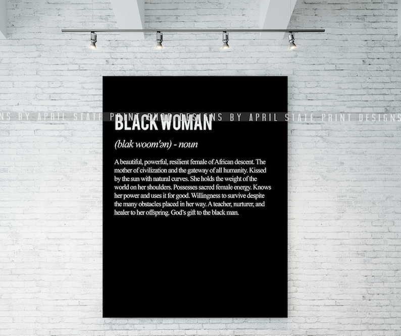 black woman definition poster on brick wall