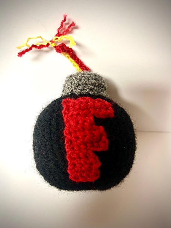 A literally handmade 'F-Bomb' — a crocheted bomb with a little F on it — the kind of pun you can actually hold and throw at someone.