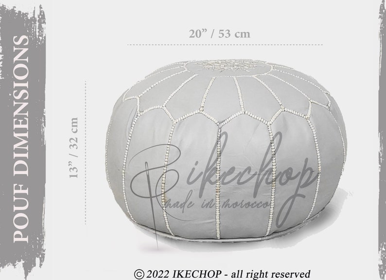 May include: A gray leather pouf with white stitching, measuring 20 inches in diameter and 13 inches in height. The pouf has a traditional Moroccan design with a hexagonal pattern.