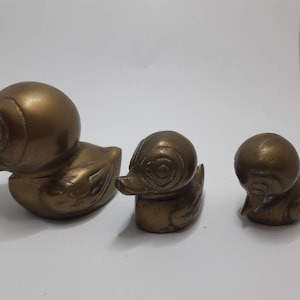 Vintage brass ducks family