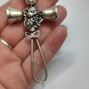 Antique 800 solid silver rattling baby toy with  pink enameled cat design