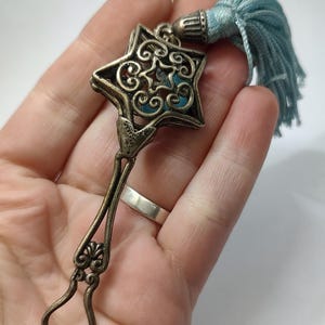 Vintage hallmarked sterling silver rattling baby toy with star design