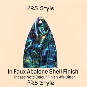 May include: A faux abalone shell guitar pick in a PRS style. The pick has a hole in the top and a blue, green, and purple iridescent finish. "PRS Style" is written in black text at the top of the image. "In Faux Abalone Shell Finish" is written in black text at the bottom of the image. "Please Note Colour Finish Will Differ" is written in black text below the previous text. "PRS Style" is written in black text below the previous text.