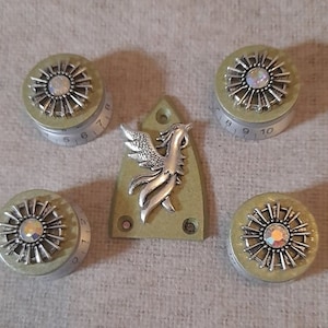 May include: Set of five green knobs with silver accents and a silver phoenix design. The knobs have numbers 5-10 and 1-2 printed on them.