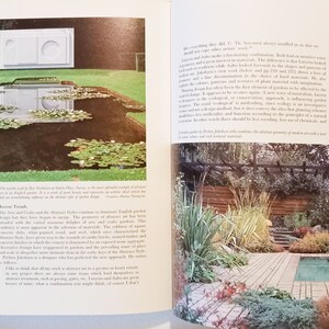 May include: Two pages from a book about garden design. The left page shows a black and white photo of a modern garden with a pond and a white sculpture. The right page shows a color photo of a modern garden with a wooden deck, a swimming pool, and a pergola.