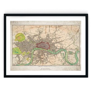 May include: An antique map of London, England, with a red outline around the city centre. The map is printed on aged paper with a light brown background and features a green river winding through the city.