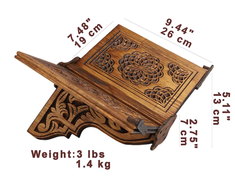 May include: Wooden book stand with intricate carved floral designs. The stand is 9.44 inches (26 cm) wide, 5.11 inches (13 cm) tall, and 7.48 inches (19 cm) deep. It weighs 3 lbs (1.4 kg).
