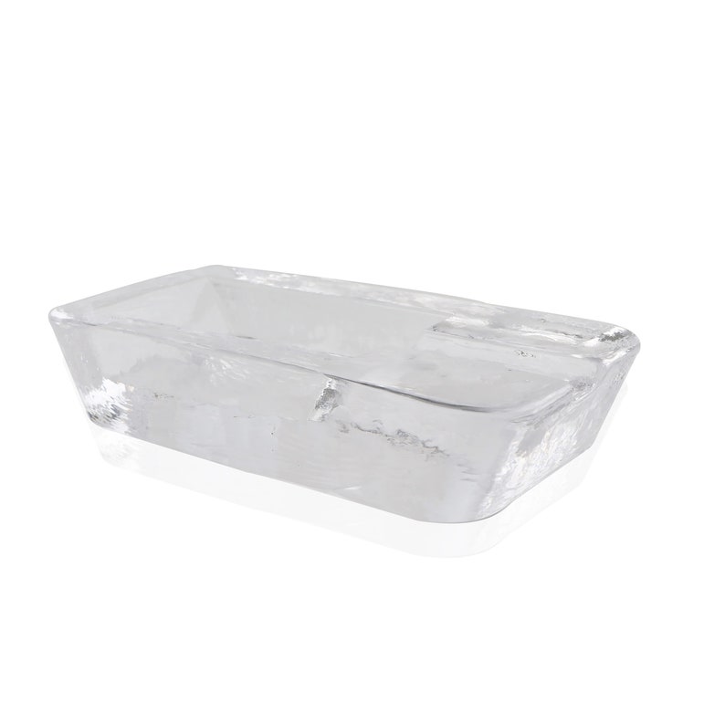 May include: A clear glass rectangular dish with rounded edges. The dish is empty and has a slight reflection on the surface.