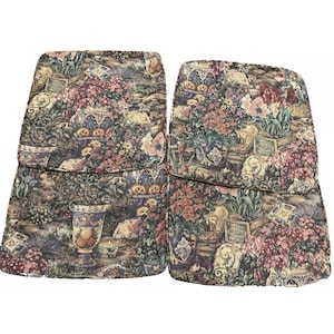 May include: Two upholstered chair cushions with a floral tapestry design. The cushions feature a mix of colors including pink, green, and brown. The cushions have a decorative pattern with a vase and the word "Bulbs".