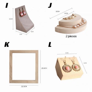 May include: Four wooden display stands for jewelry. The stands are made of natural wood and are designed to hold earrings, necklaces, and bracelets. The stands are all different sizes and shapes, and they are perfect for displaying jewelry in a retail setting or at home. The stands are 6 cm, 8.5 cm, 15 cm, 20 cm, 22.5 cm, 25.6 cm in size.