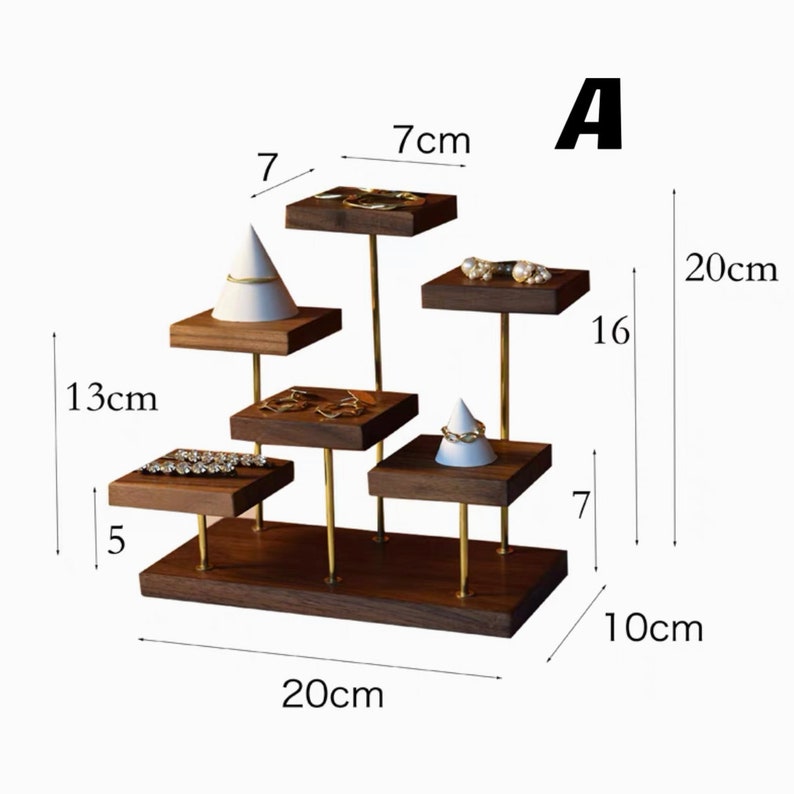 May include: A wooden jewelry display stand with five tiers. The stand is 20 inches wide and 10 inches tall. The stand has a gold metal frame and is made of dark wood.