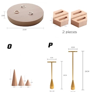 May include: Set of wooden and metal jewelry display stands. The set includes a round wooden ring stand, two hexagonal wooden ring stands, three wooden cone stands, and two metal T-shaped stands. The stands are all different sizes and are perfect for displaying rings, earrings, necklaces, and other jewelry.