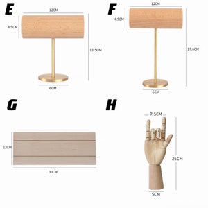 May include: Four wooden display stands for jewelry. The stands are made of natural wood and have a gold metal base. The stands are different sizes and shapes. The first stand is 12 inches long and 4.5 inches tall. The second stand is 12 inches long and 4.5 inches tall. The third stand is 12 inches long and 4.5 inches tall. The fourth stand is 7.5 centimeters long and 25 centimeters tall.